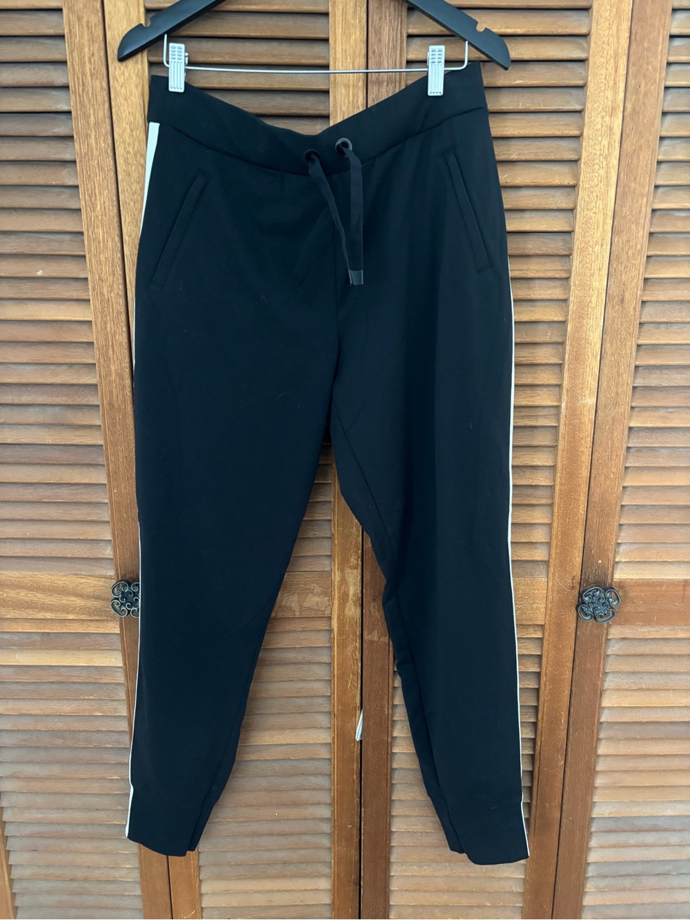 Athleta Black Ribbed joggers with Logo Tag white stripes down the side size lg